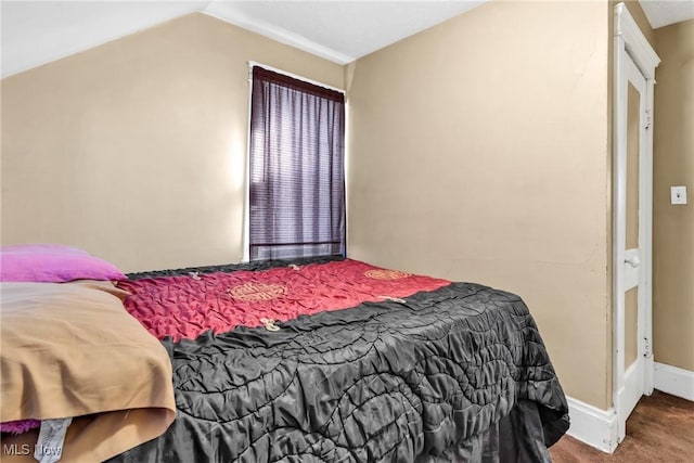 carpeted bedroom featuring lofted ceiling