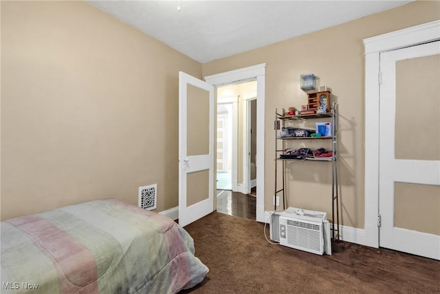 bedroom with dark colored carpet