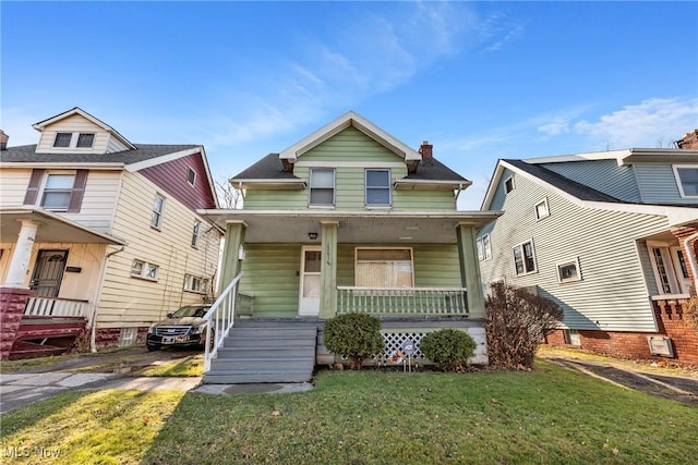 view of front of house featuring a front yard and covered porch