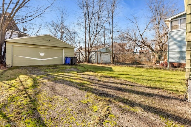 view of yard with a garage and an outdoor structure