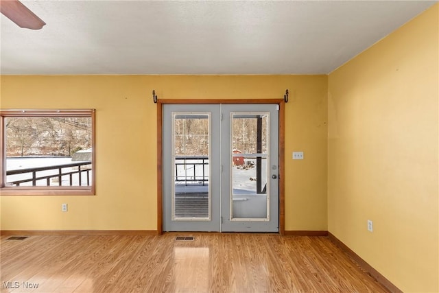 entryway featuring light wood-type flooring and ceiling fan