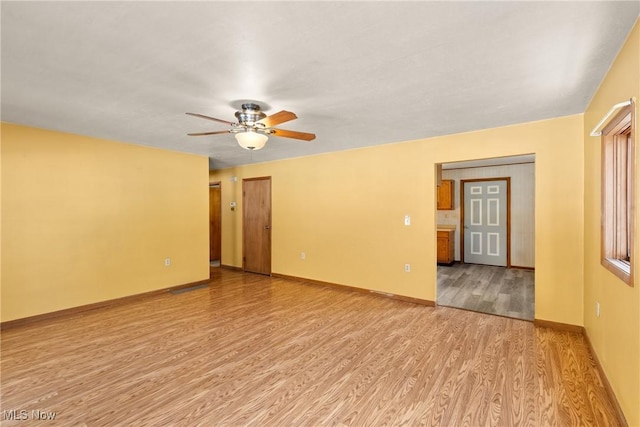 unfurnished room with ceiling fan and light hardwood / wood-style flooring