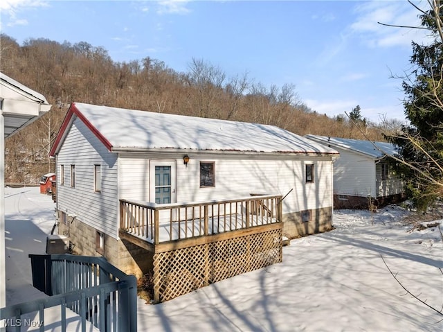 back of property featuring a wooden deck