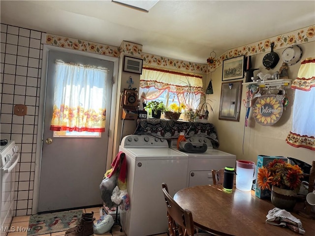 washroom with separate washer and dryer, tile patterned floors, and electric panel