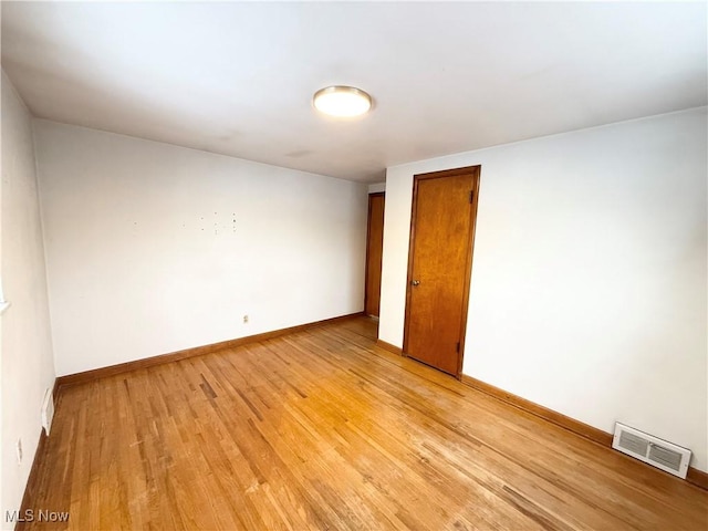 unfurnished room with light hardwood / wood-style flooring