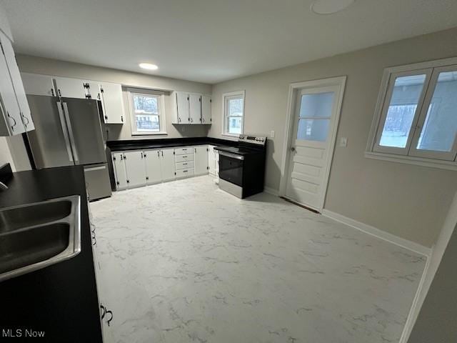 kitchen featuring white cabinets, appliances with stainless steel finishes, and sink