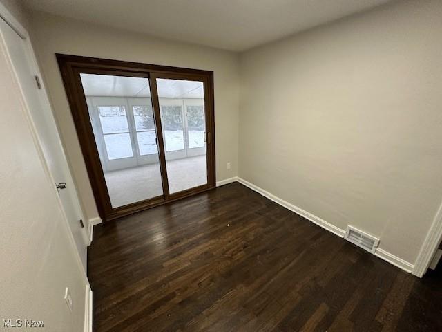 empty room featuring dark hardwood / wood-style floors