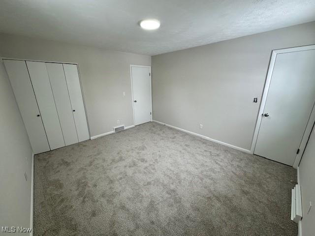 unfurnished bedroom featuring carpet flooring