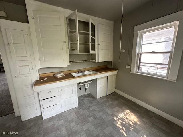 unfurnished office featuring built in desk and sink