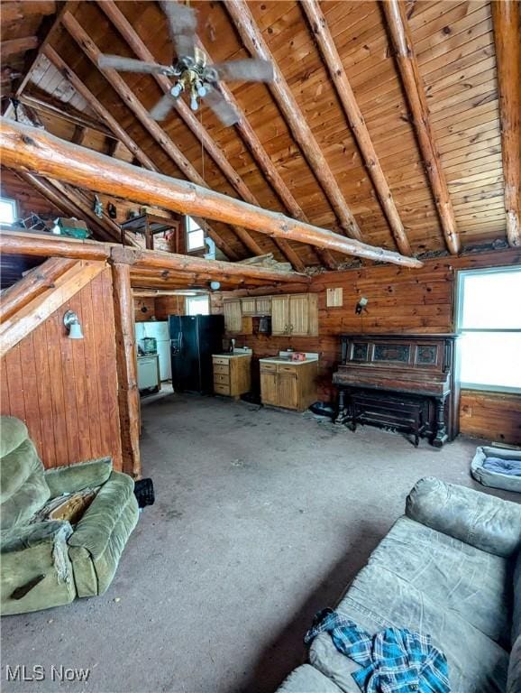 unfurnished living room featuring vaulted ceiling with beams, wood ceiling, and wooden walls