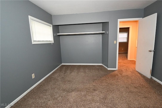 unfurnished bedroom with carpet and a closet