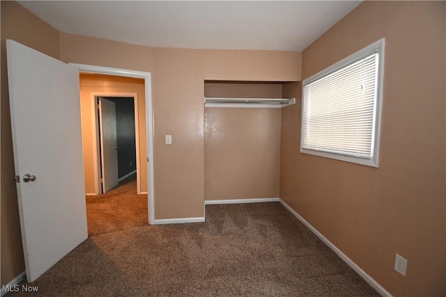 unfurnished bedroom with carpet floors and a closet