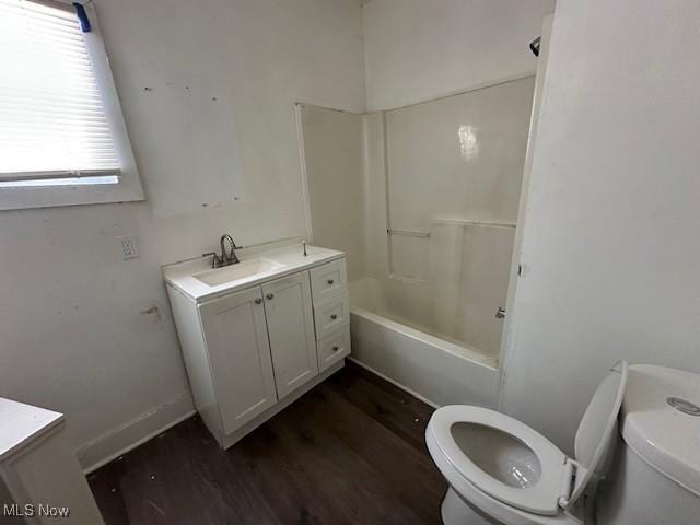 full bathroom with hardwood / wood-style flooring, shower / bathing tub combination, toilet, and vanity