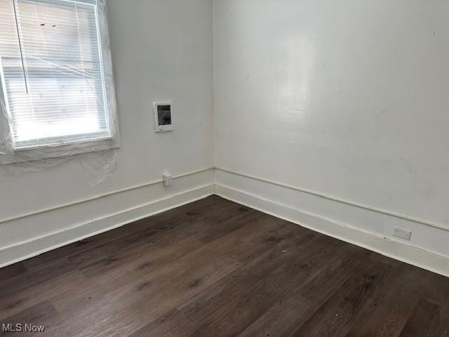 empty room featuring dark wood-type flooring