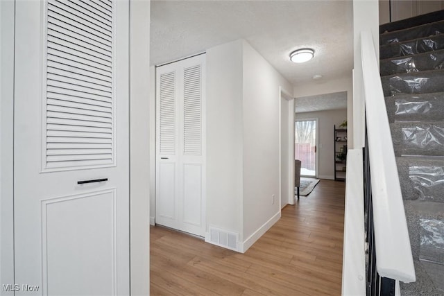 corridor featuring light hardwood / wood-style floors