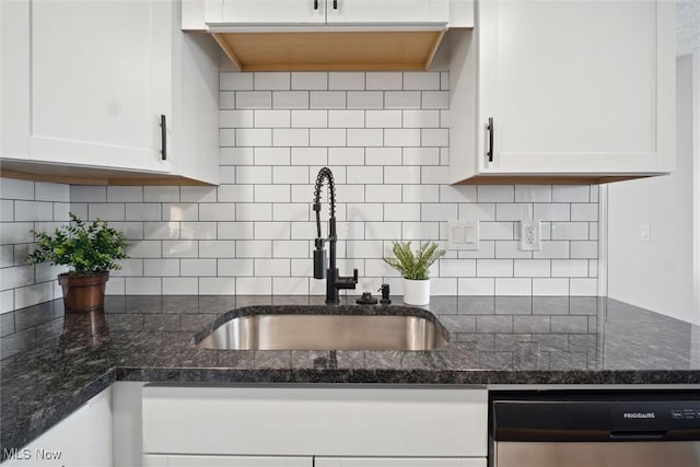 kitchen with white cabinetry, decorative backsplash, dishwasher, and sink