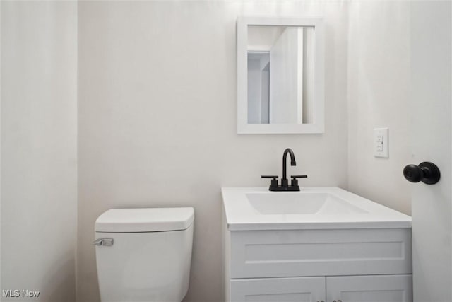 bathroom with toilet and vanity