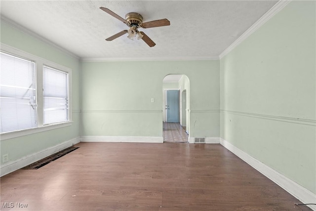 unfurnished room with ceiling fan, wood-type flooring, crown molding, and a textured ceiling