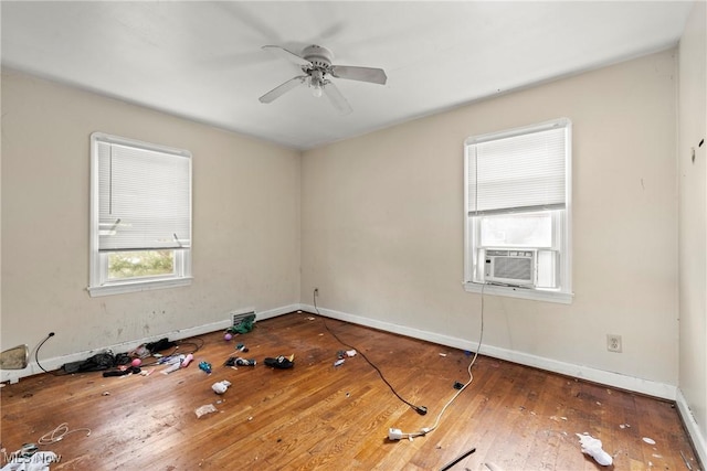 unfurnished room with ceiling fan, dark hardwood / wood-style flooring, and cooling unit