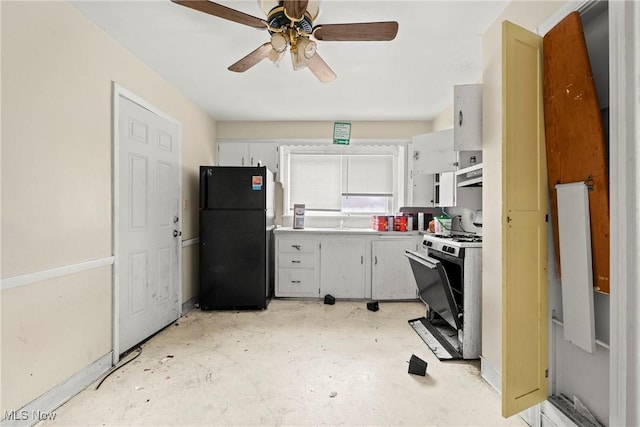 kitchen featuring ceiling fan, range with gas cooktop, sink, white cabinetry, and black refrigerator