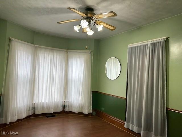 unfurnished room featuring wood-type flooring and ceiling fan