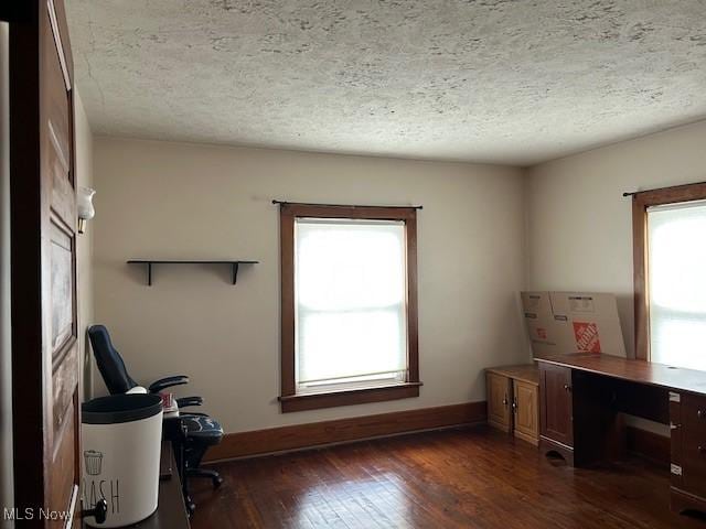 office area featuring dark wood-type flooring and a textured ceiling