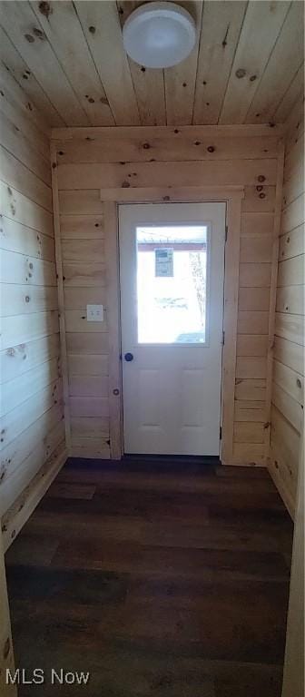 entryway featuring dark wood-type flooring, wood ceiling, and wood walls