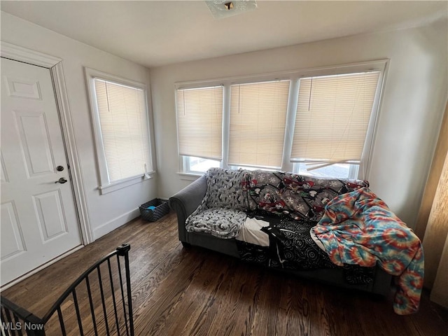 bedroom with dark hardwood / wood-style flooring