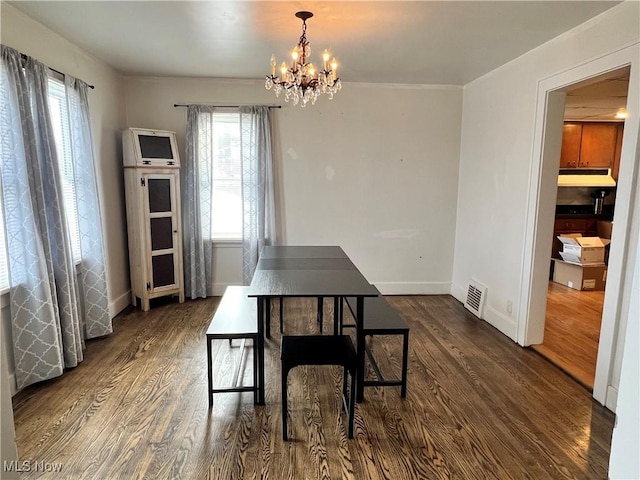 dining room featuring dark wood-type flooring and a notable chandelier