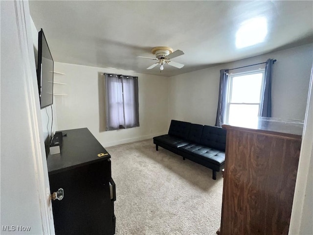 sitting room with ceiling fan and carpet flooring