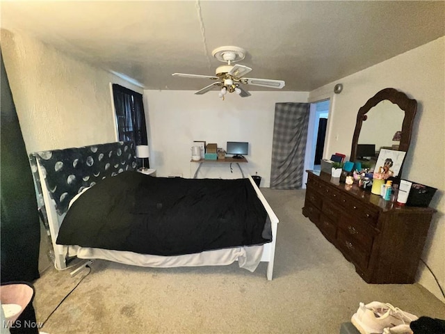 bedroom with ceiling fan and light carpet