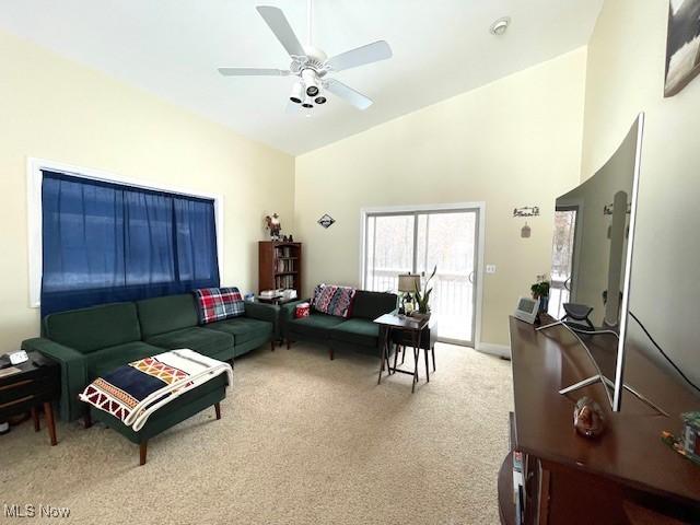 living room featuring carpet floors, high vaulted ceiling, and ceiling fan