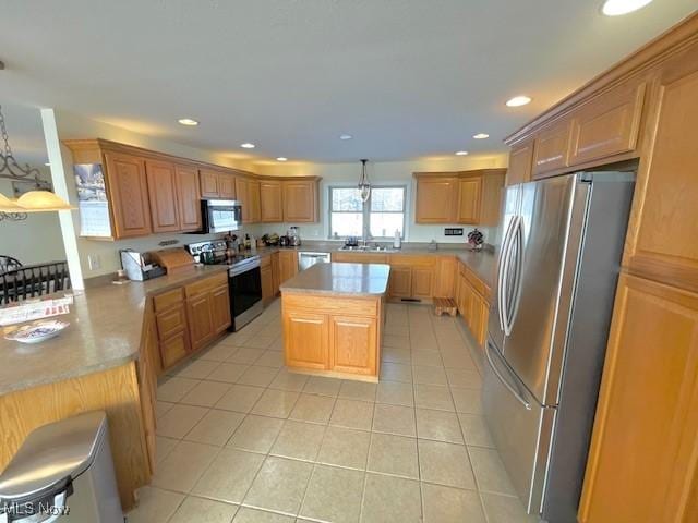 kitchen with light tile patterned flooring, a kitchen island, decorative light fixtures, kitchen peninsula, and stainless steel appliances