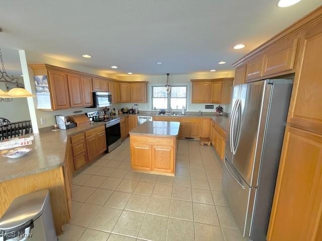7716 N Ridge Pl, Lisbon, OH 44432 - kitchen with stainless steel appliances, recessed lighting, light tile patterned floors, light countertops, and a kitchen island