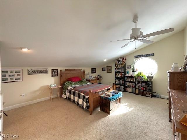 bedroom with light carpet, vaulted ceiling, and ceiling fan