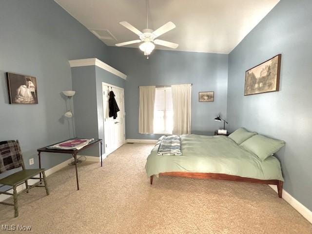 carpeted bedroom featuring high vaulted ceiling and ceiling fan