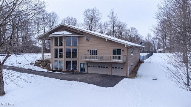 snow covered house with a garage