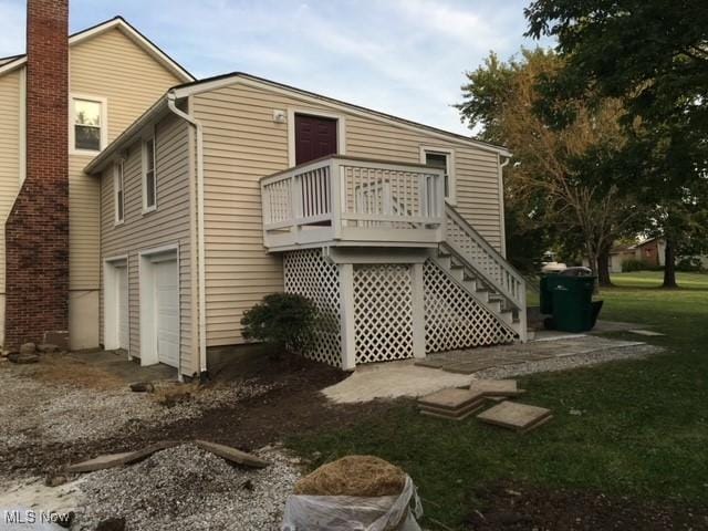 rear view of property featuring a garage