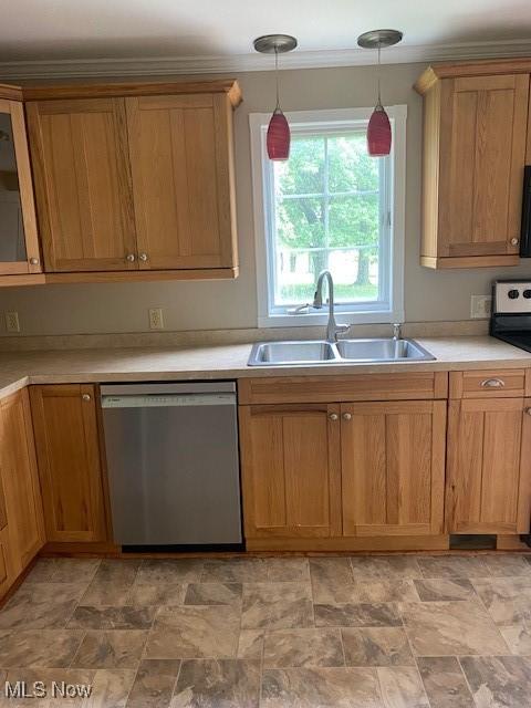 kitchen with appliances with stainless steel finishes, sink, ornamental molding, and pendant lighting