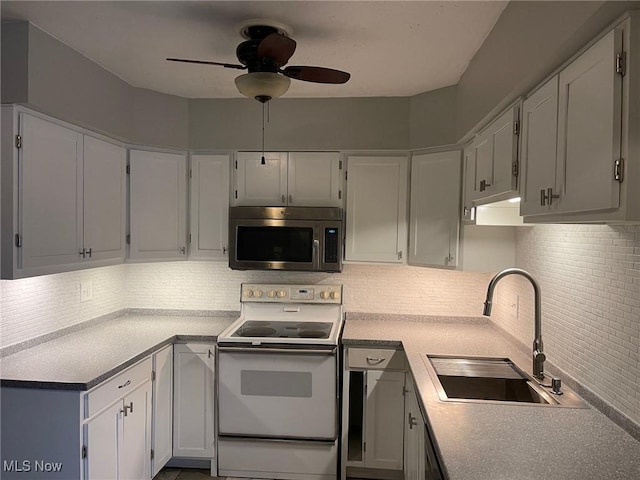 kitchen featuring white cabinetry, decorative backsplash, white electric stove, and sink