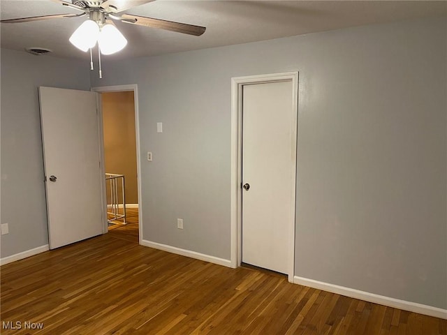 unfurnished bedroom with ceiling fan and hardwood / wood-style flooring