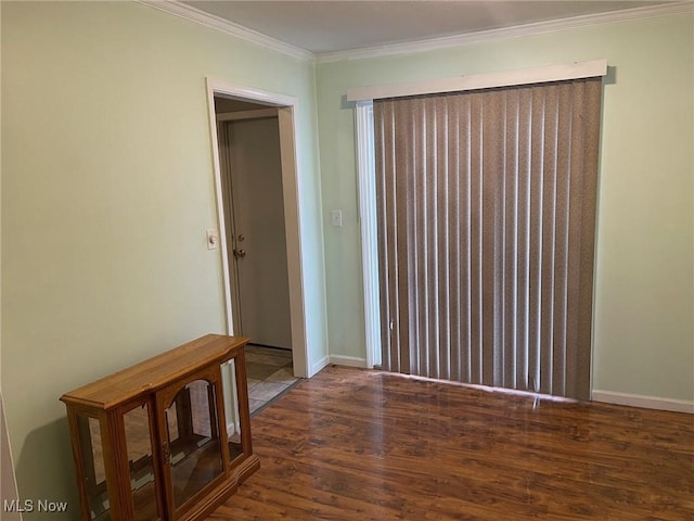 empty room featuring dark hardwood / wood-style floors and crown molding