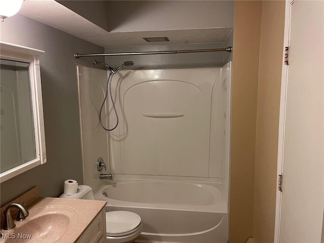 full bathroom featuring toilet, vanity, and bathtub / shower combination