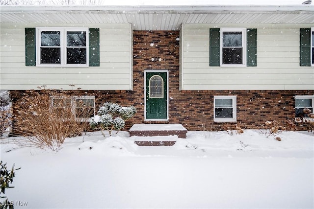 view of snow covered property entrance