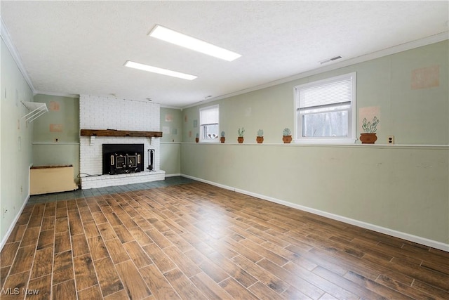 unfurnished living room with ornamental molding, a fireplace, and plenty of natural light