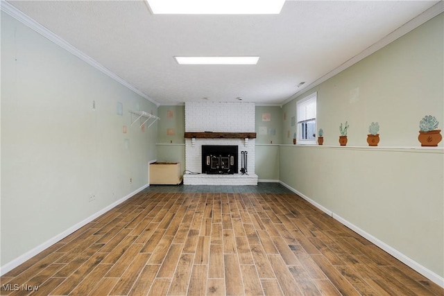 unfurnished living room with a brick fireplace, wood-type flooring, and crown molding