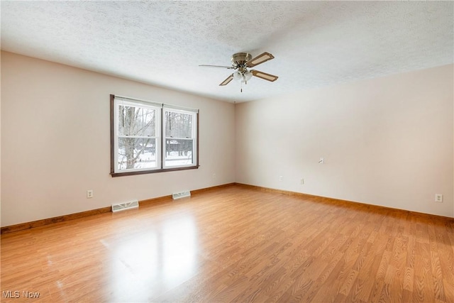 unfurnished room featuring light hardwood / wood-style floors, a textured ceiling, and ceiling fan