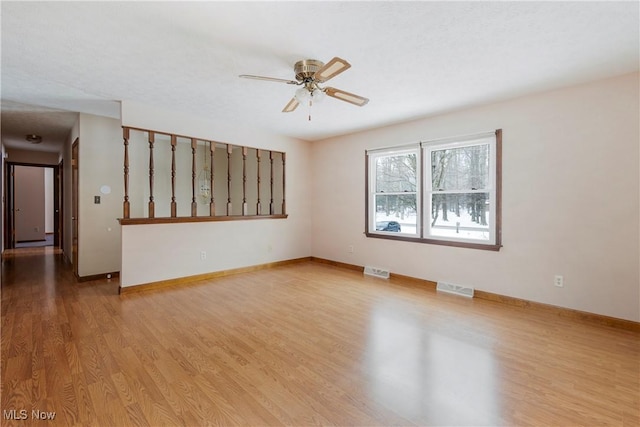 empty room with ceiling fan and light wood-type flooring