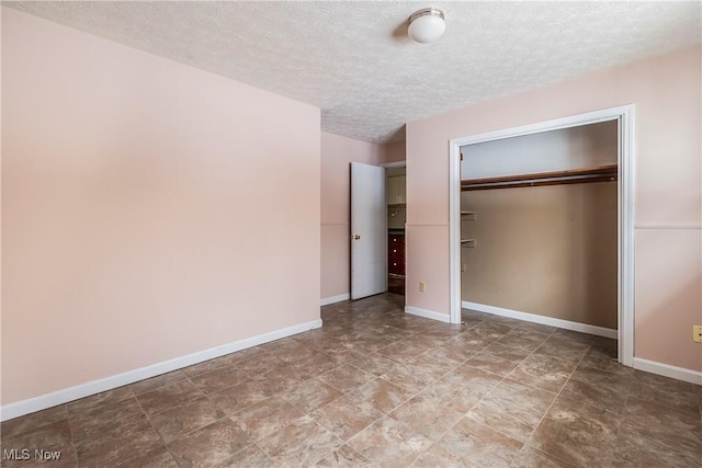 unfurnished bedroom featuring a closet and a textured ceiling