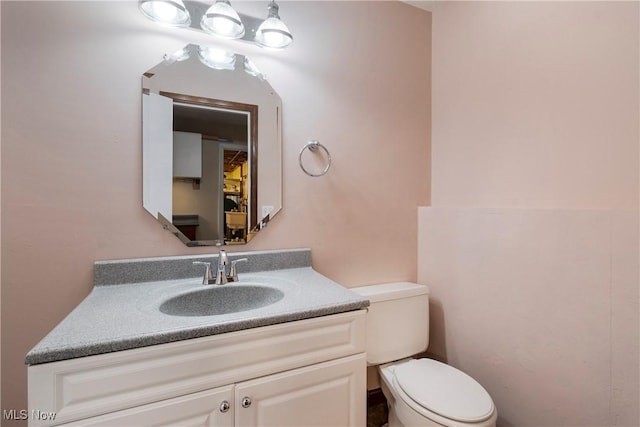 bathroom featuring toilet and vanity